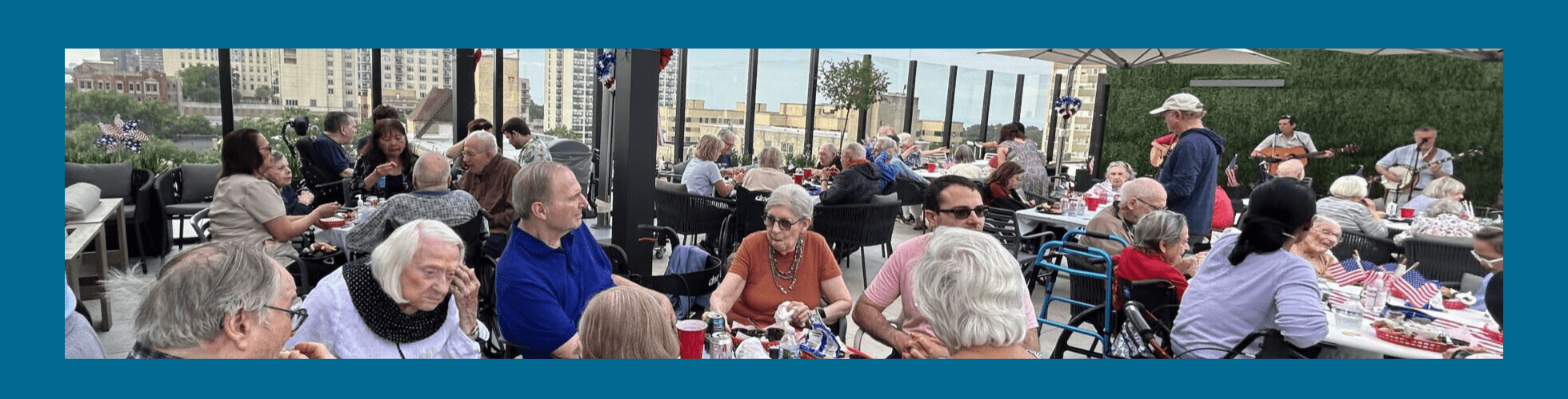 Photo of residents of The Selfhelp Home enjoying a rooftop picnic